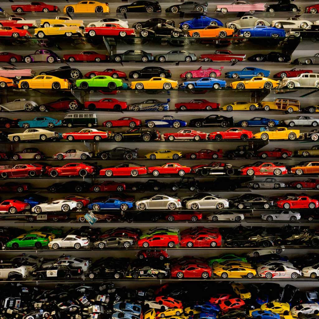 small diecast cars displayed on a neat shelf